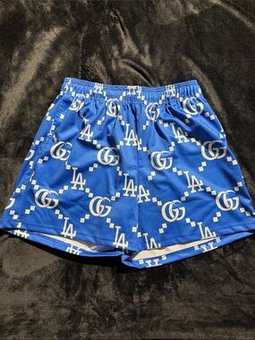 Bravest Studios Blue Athletic Shorts with White Logo Pattern